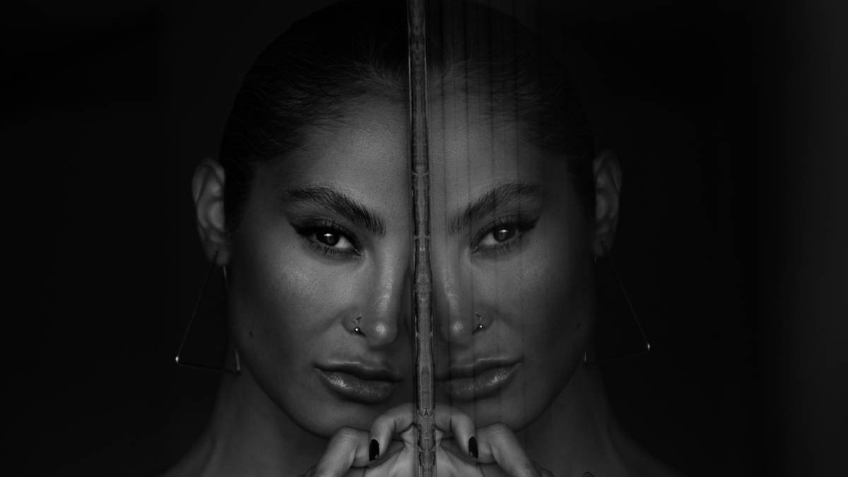 a woman with piercings on her face behind bars