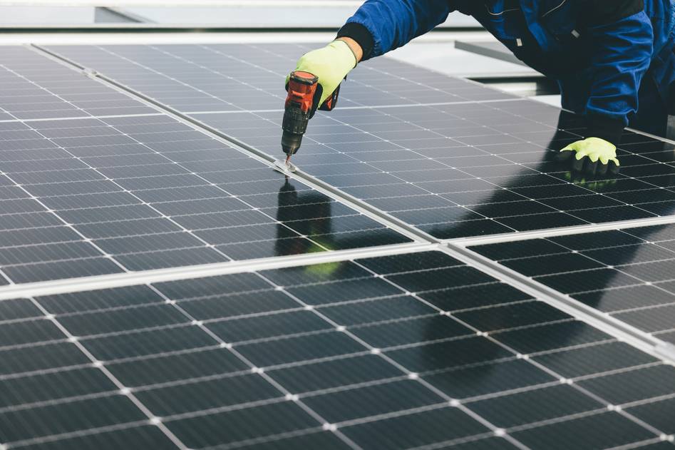 Team discussing bifacial solar panel efficiency in modern eco-home