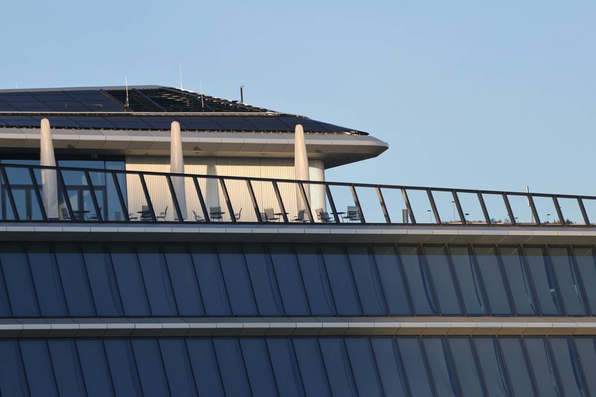 bifacial solar panels on roof with elevated mounting showing rear-side exposure to reflected sunlight